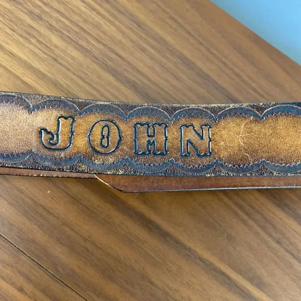 Vintage brown leather hand tooled Western belt.